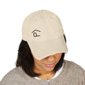 Distressed Lazy P Diabetes Hat worn by a woman, showcasing a beige ball cap with logo embroidery.