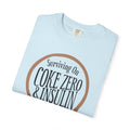 Surviving on Coke Zero Western Diabetes Tshirt featuring a curled rope design on a light blue background.