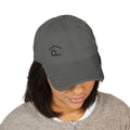 Distressed Lazy P Diabetes Hat worn by a woman, showcasing the embroidered Lazy P logo in dark gray.