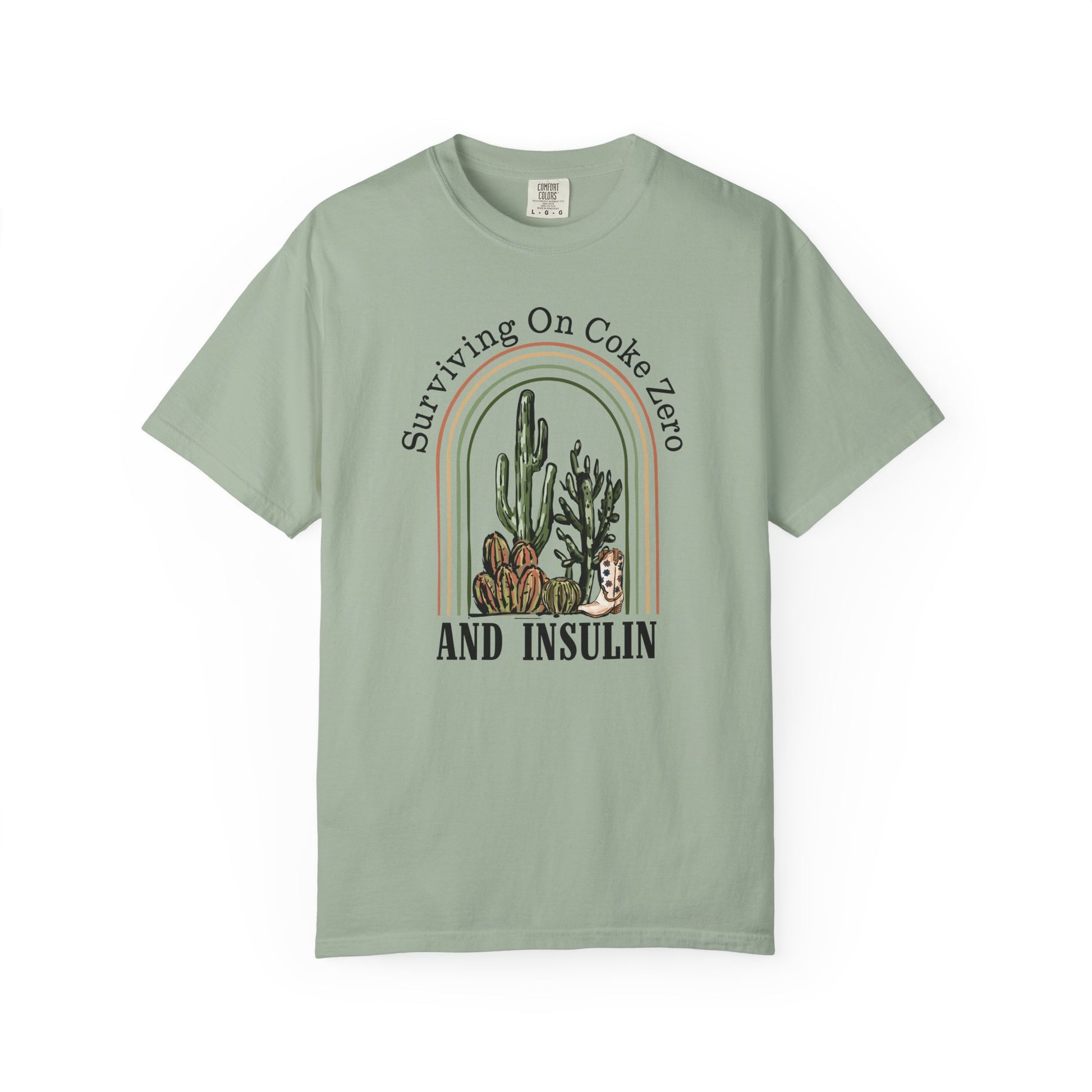 Surviving on Coke Zero Diabetes TShirt featuring cacti design on a soft, mint green fabric.