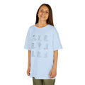 Boots and Insulin Kids Diabetes Tshirt worn by a smiling girl, showcasing cowboy boot designs on a light blue shirt.