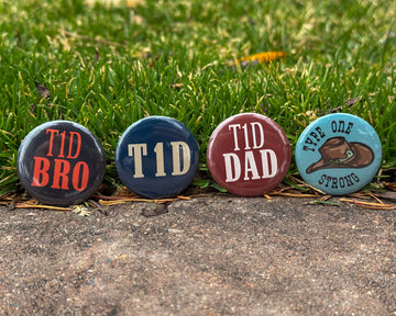 Four diabetes awareness buttons with text on a grassy background