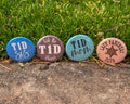 Four diabetes awareness buttons with text and designs on a grassy background